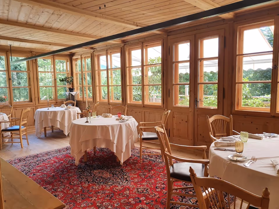 The panelled dining room of Restaurant Schöneck, tables laid for service