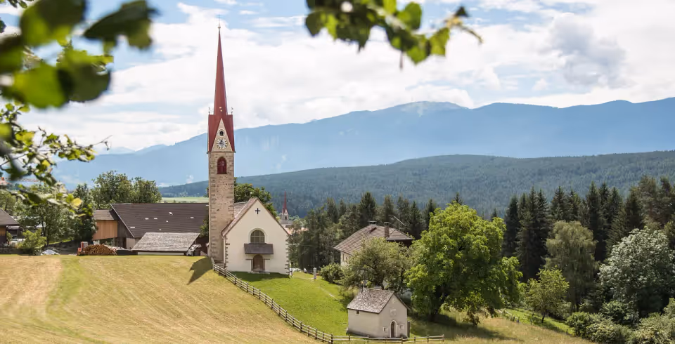 Late-Gothic church spire on the Four Churches Trail above the Puster Valley